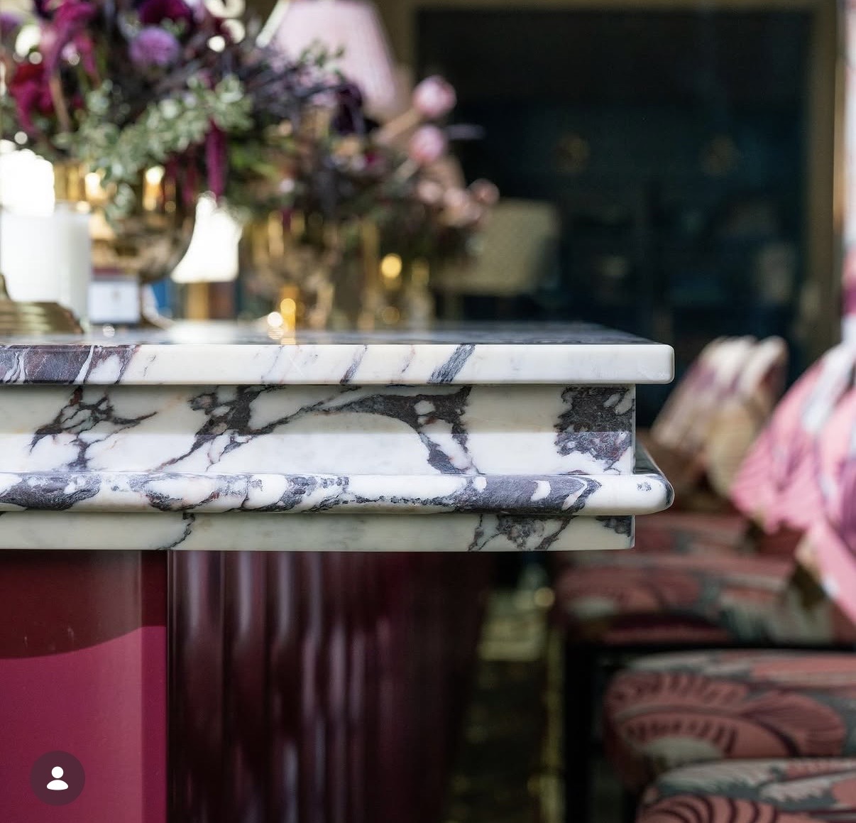 Arnold + Egan, veined marble bar top in a lounge setting